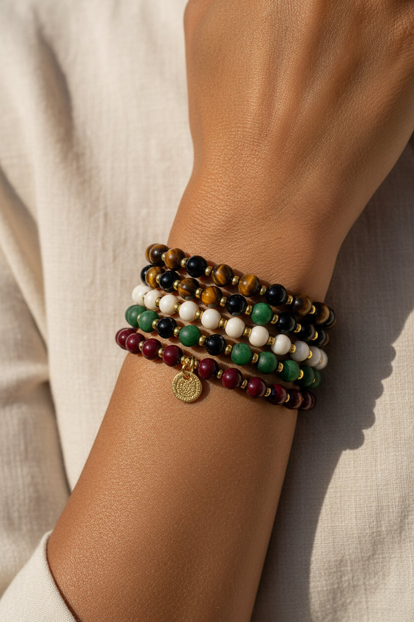 A promotional graphic for the EVA Empowered Collection, featuring text about intimate partner violence awareness and four photos of handcrafted beaded bracelets in various colors and materials.